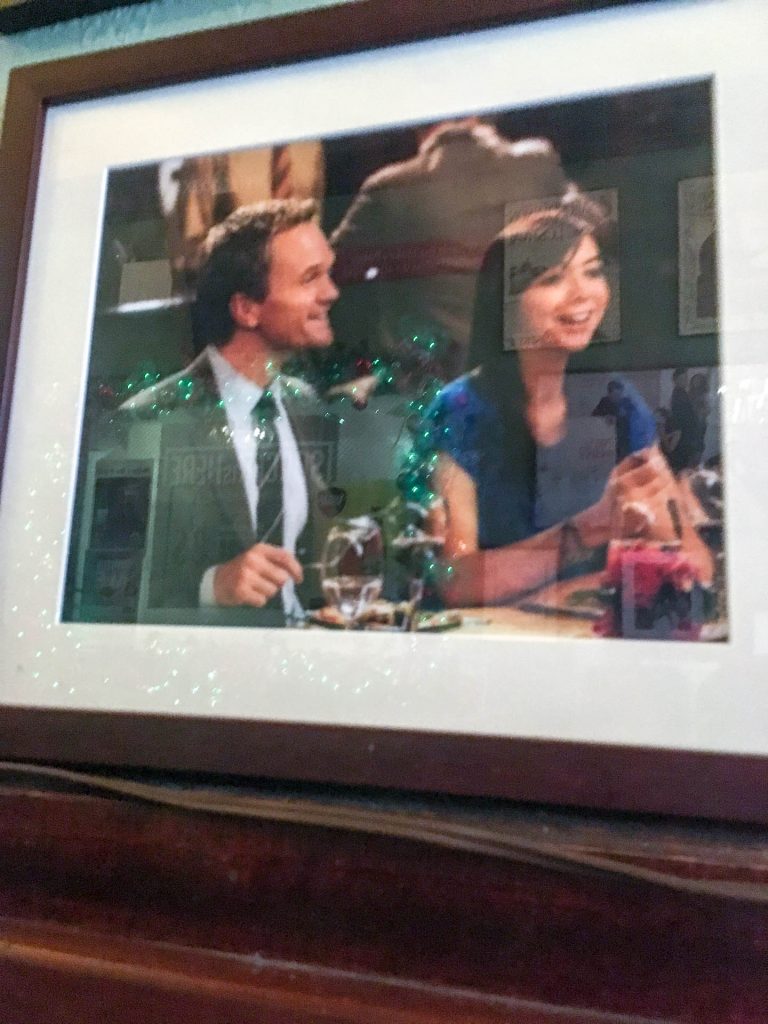 Barney and Lily from How I Met Your Mother drinking at the bar.